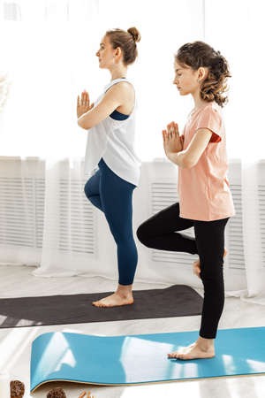 Yoga Trainer Assisting Student